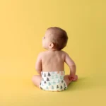 Best Babyshop in Kochi- A baby is sitting& he is only wearing the diaper